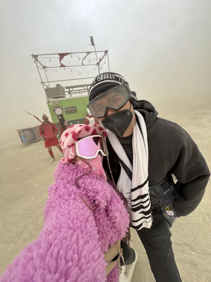 Ysabelle and Jordan in goggles and dust gear during a whiteout on the playa