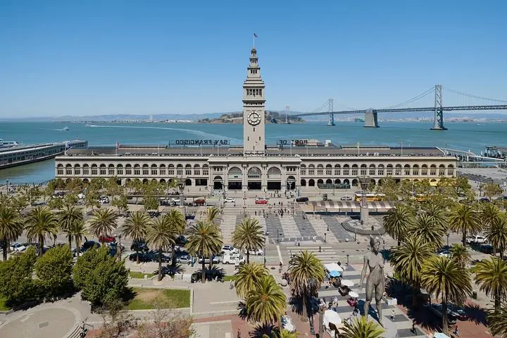 The Ferry Building clock tower on the Embarcadero, with the Bay Bridge behind it