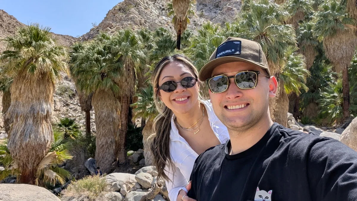 Ysabelle and Jordan among the palms on their Joshua Tree trip